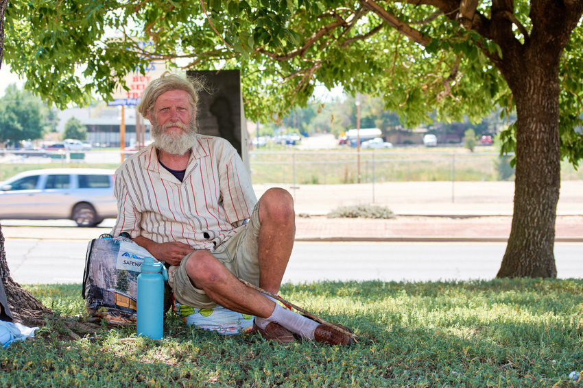 Paul Johnson, a Lakewood native and recently back on the streets after being kicked out of public housing, sits feet from the ArtLine beside Lamar Station Plaza.